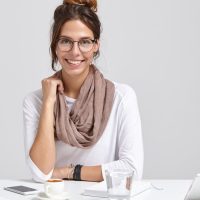 smiling-businesswoman-round-spectacles_273609-28812