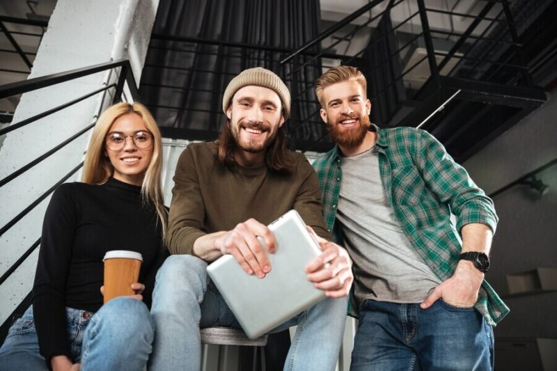 smiling-colleagues-office-using-tablet-computer