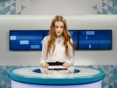 tv-present-studio-preparing-new-broadcasting-smiling-girl-white-shirt-sitting-table_1157-47908