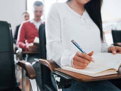 with-notepad-pen-hands-group-people-business-conference-modern-classroom-daytime_146671-16255