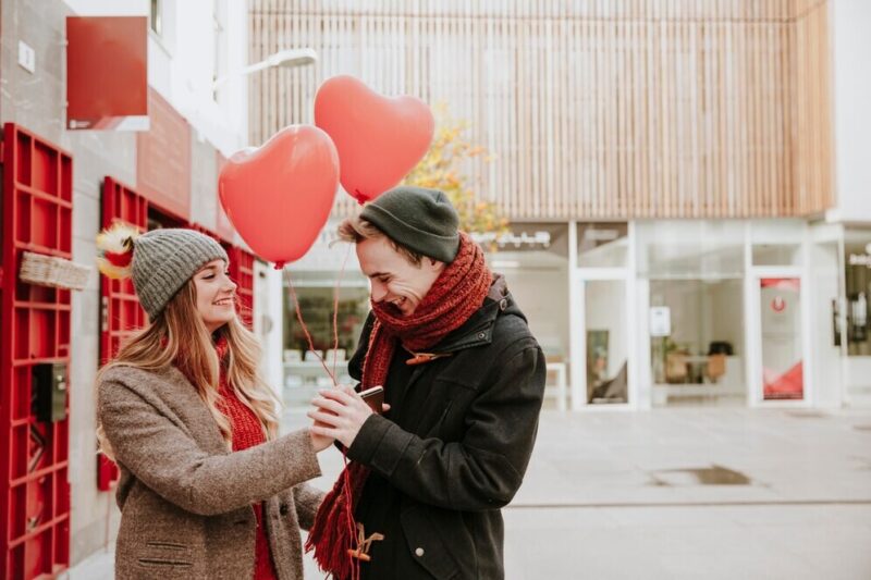 woman-giving-heart-balloons-smiling-boyfriend_23-2147736013