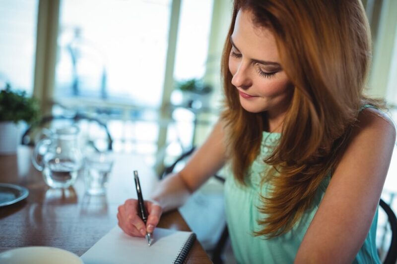 woman-writing-notepad_1170-734