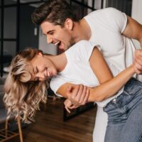 wonderful-girl-white-t-shirt-dancing-with-boyfriend-indoor-portrait-winsome-lady-fooling-around-home-with-husband_197531-12199