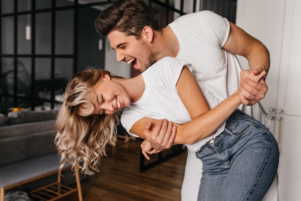 wonderful-girl-white-t-shirt-dancing-with-boyfriend-indoor-portrait-winsome-lady-fooling-around-home-with-husband_197531-12199