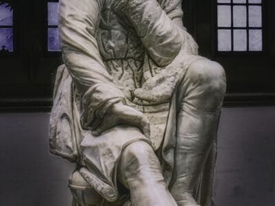 woman in dress statue in grayscale photography