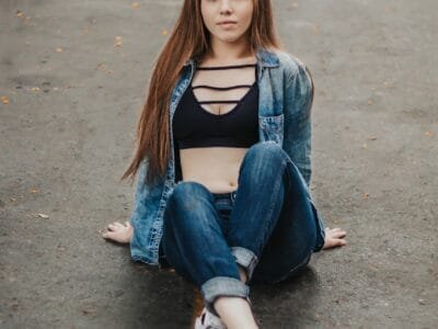 a woman sitting on the ground with her legs crossed