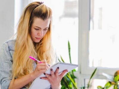 young-girl-writing-notepad_23-2147656256