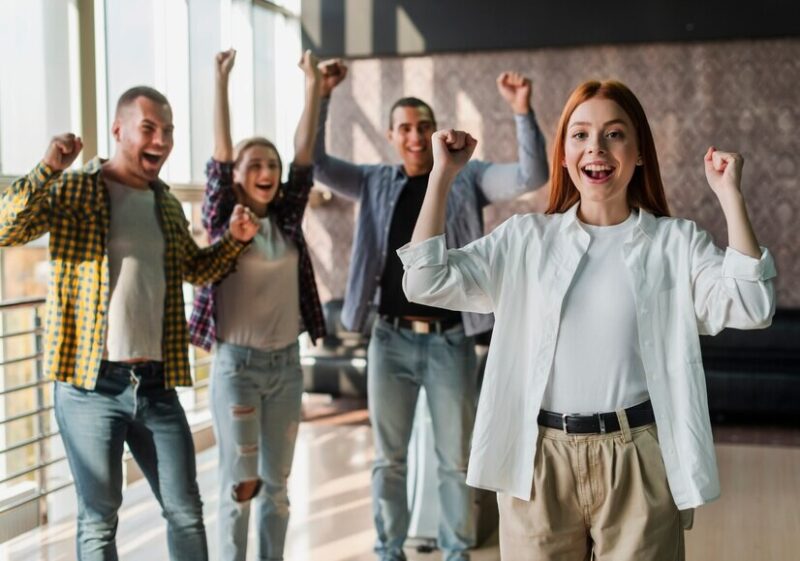 young-happy-friends-standing-bowling-club