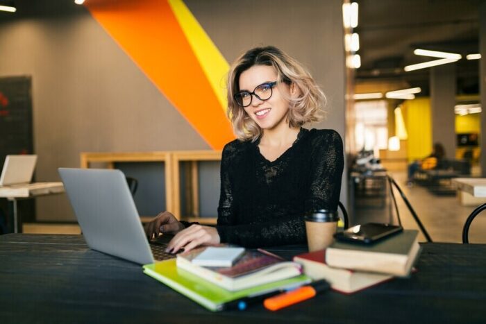 young-woman-working-laptop-co-working-office