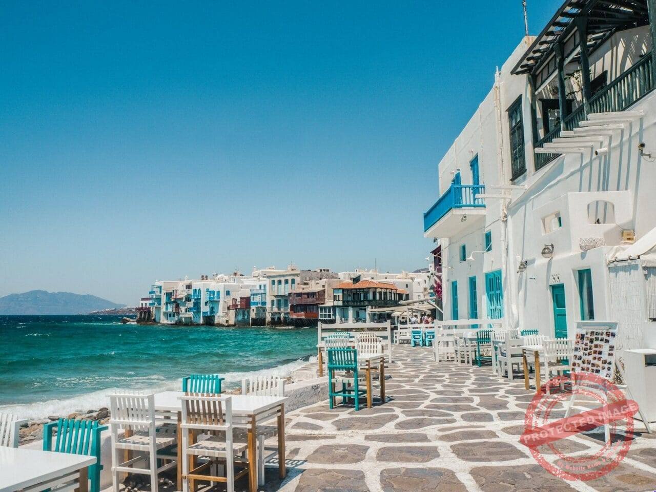 white and brown concrete buildings near sea during daytime